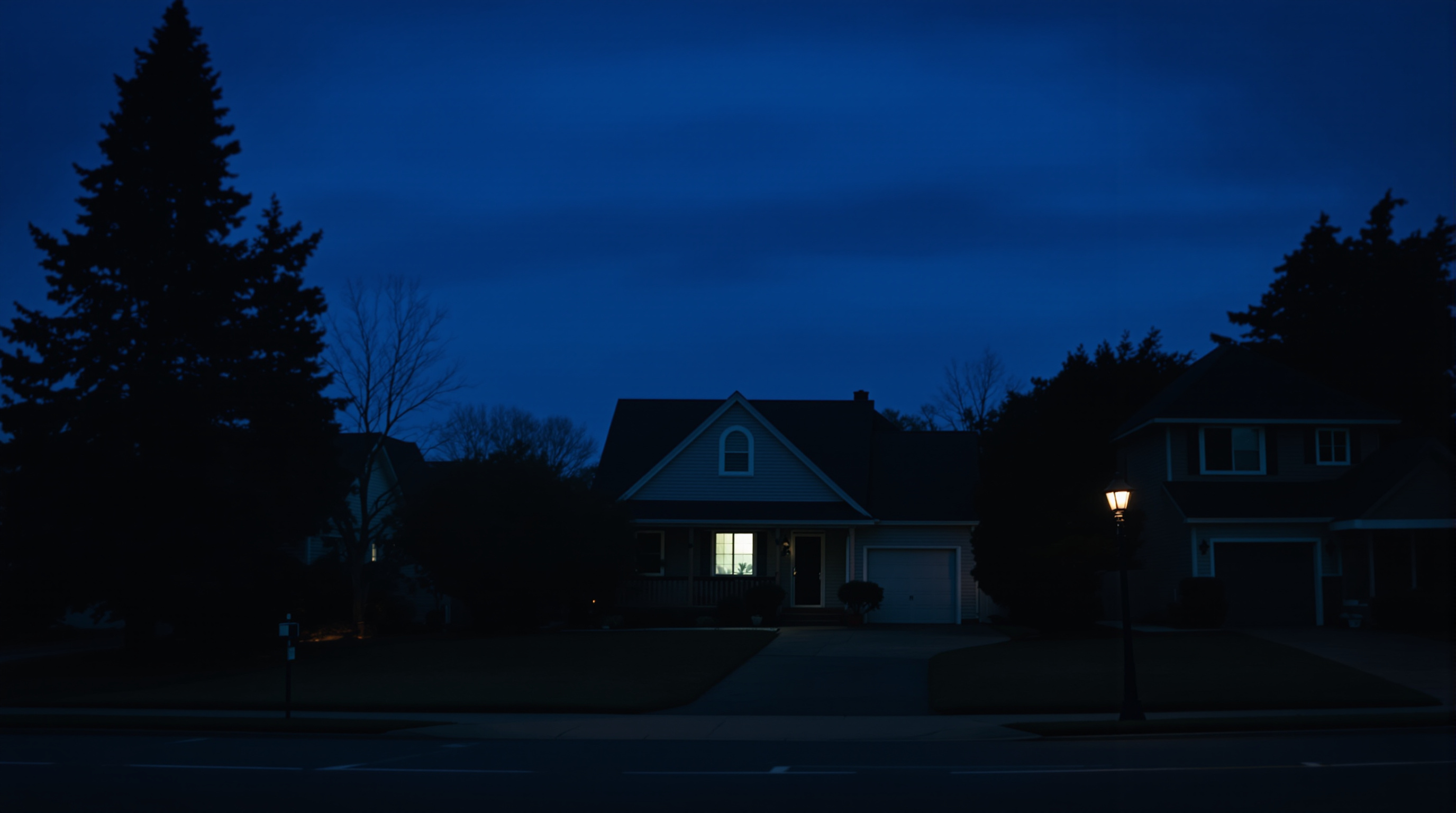 Front door of a house with a handwritten note taped to it and a dark porch
